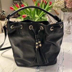 Henri Bendel black bucket bag with gold hardware.